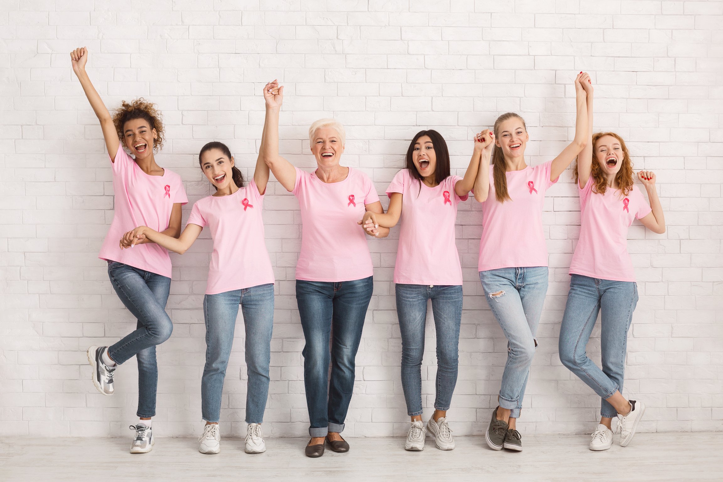 Diverse Ladies In Breast Cancer T-Shirts Celebrating Success Indoor